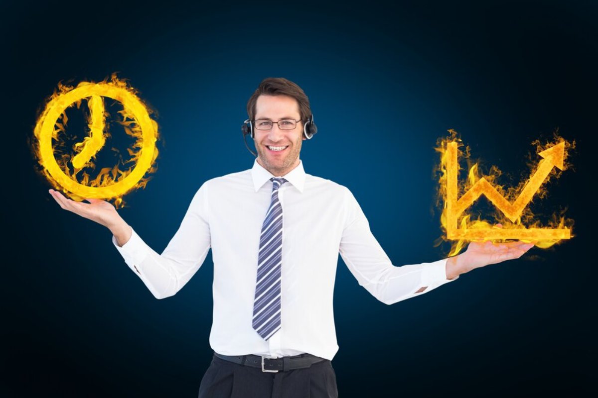 A smiling man in headset holds fiery symbols of a clock and an upward arrow.