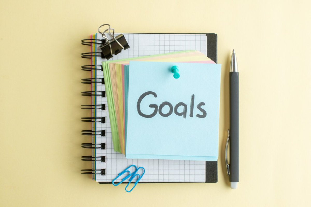 Stack of colorful notebooks with a 