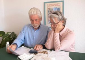 An older couple reviews financial documents and planning for their retirement.
